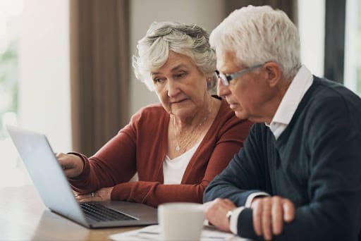 Senior couple looking at laptop