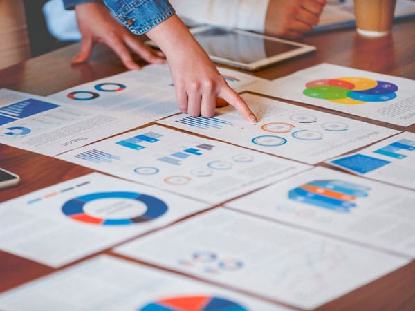 Individuals looking at circle and line graphs of data.