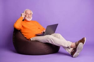 senior man reclines and enjoys a website using best practices in Senior Living Website Design