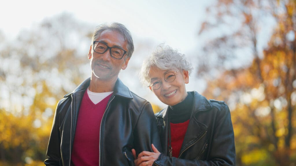 a smiling senior couple outside in autumn