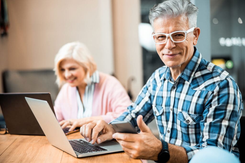 Older couple reviewing senior living content on a laptop as part of a senior services marketing plan