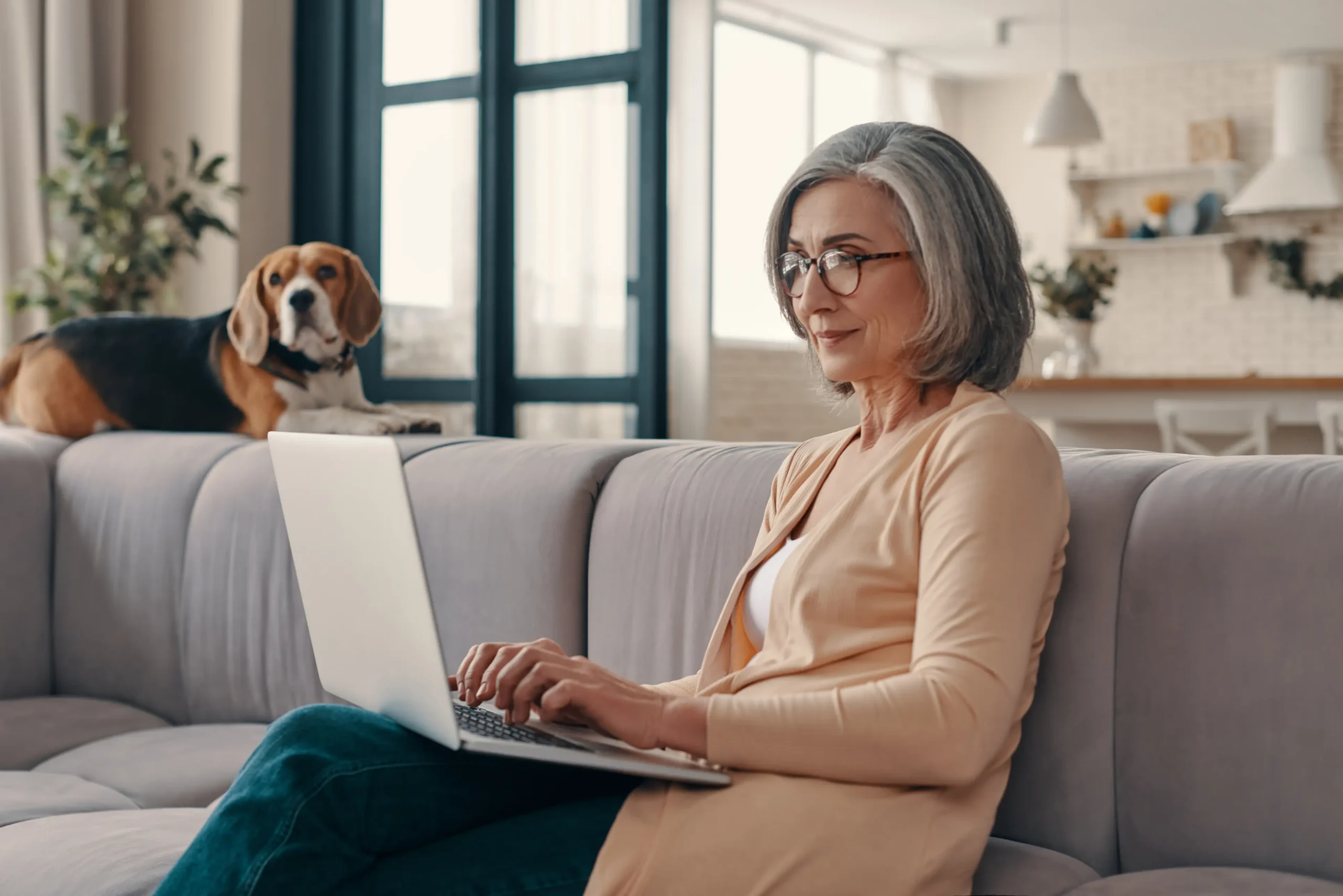 Senior woman browsing the internet on her laptop